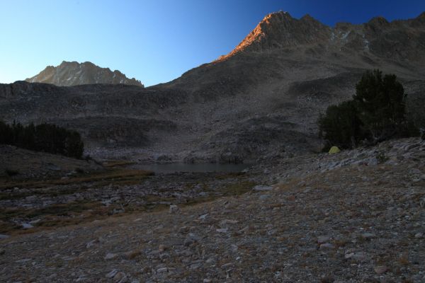 Peak 10906', 0.5 mi SW of Patterson Peak, catches the first rays of morning light above my camp high in Four Lakes Basin.  The north face of Castle Peak is seen again beyond the ridge.
