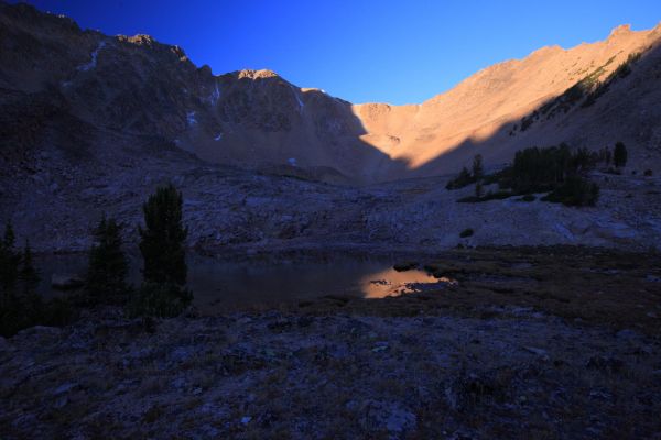 The morning light on the peak is reflected in the lake adjacent to my camp.
