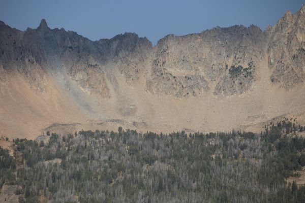 The "large gray pinnacle on a fractured ridge guards a notch called the Devil's Staircase," above the highest of the Born Lakes from the divide west of Ants Basin.
