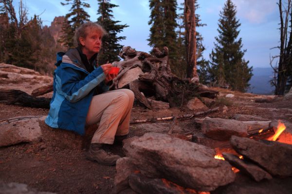 Enjoying her soup, the professor gets a double dose of orange light; from the alpenglow, and the fire.
