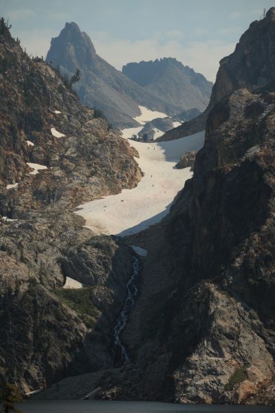 Four climbers descend soft snow in the late afternoon; the couloir above Goat Lake.
