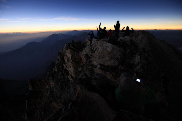 As I imagined, there appeared to be daylight on the southern horizon.  The digital back of Mike's camera shows brightly in the dim light of totality. 
