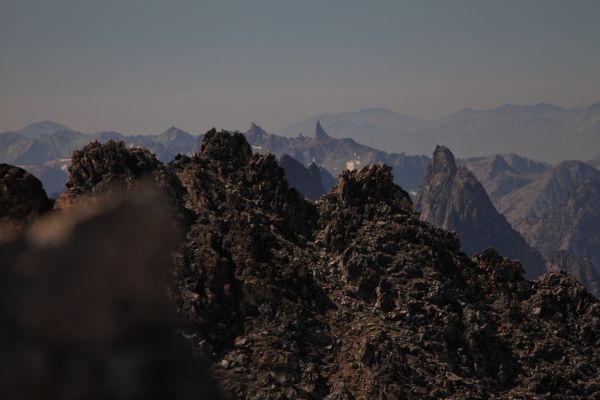 2 miles southwest as the crow files, North Raker is the unmistakable shark fin centered on the mid-distant ridge.  No easy route on this peak; grade 3, class 6.  Outstanding view while ascending to Ingeborg Lake above Spangle Lake in 2013.
