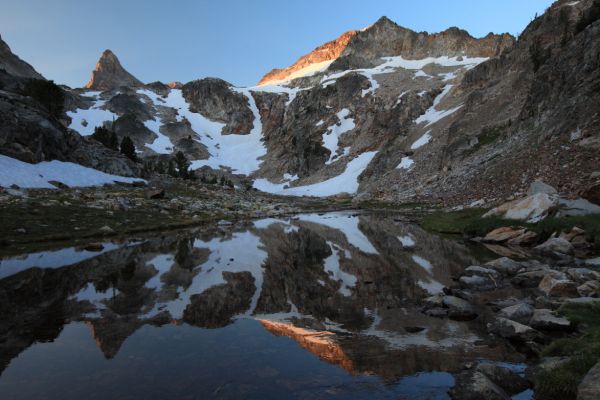 Thompson Peak and the ridge to it's west bathed in alpenglow, reflected in the tarn southwest of our camp.
