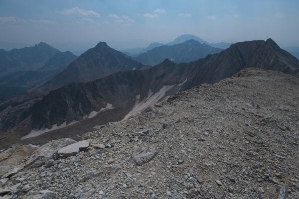 Castle Peak, obscured by smoke, in the distance, southeast from the summit of D. O. Lee Peak.
