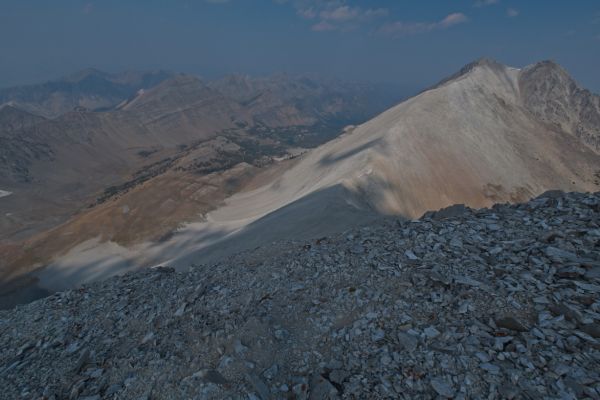 The view north into Bighorn Basin from the summit of D. O. Lee Peak.  WCP-9 rises north of the saddle.  Ocalkens Lake can barely be seen through the smoke above the saddle in the distance in the upper center of photo.
