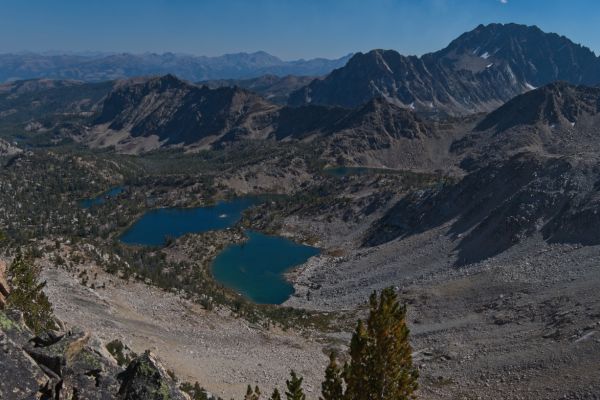 Castle Peak looms above the Boulder Chain Lakes; From high to low, Scoop Lake is just visible under Castle Peak, Hidden Lake, Hummock Lake, and Hourglass Lake; furthest left (east) are Sliderock Lake and Shelf Lake.
