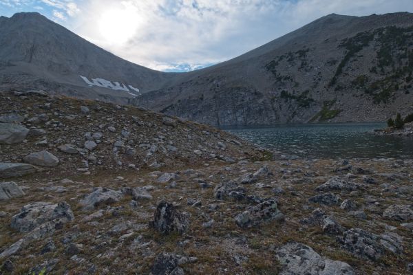 Above Cirque Lake looms the saddle I crossed in the height of a thunderstorm, just an hour before.  After descending to Cove Lake, I hurry to get the most important things out of the way; tent, food hung, water pumped.  No sooner do I accomplish these tasks, all hell breaks loose; thunder, lightning, wind and hail for forty minutes.  The storm moves east before dark, and with half an inch of hail on the ground, I am able to start dinner.  No fishing this evening!
