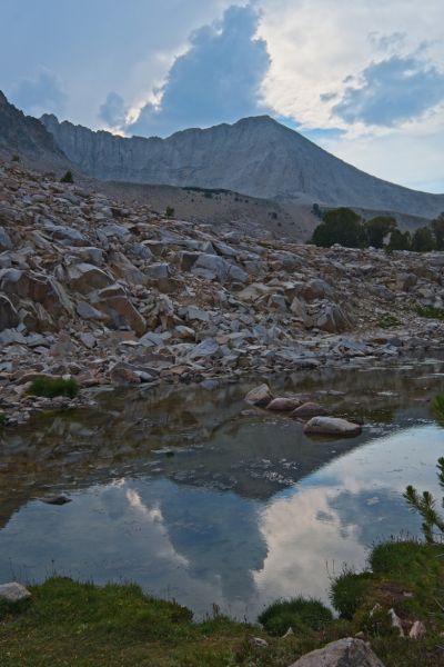 The vertical development over D. O. Lee Peak is a good indicator thundershowers are not far off.  Within 20 minutes, it starts pouring, accompanied by wind, thunder and lightning.  I retreat to my tent, taking apart my fishing pole.  I rains hard for 45 minutes and abruptly ceases.  Now all I have to do is get the fire going so I can cook the big trout—a task which proves to be much more difficult than I thought, even using my cartridge stove like a flame-thrower!  At least there is still enough light…
