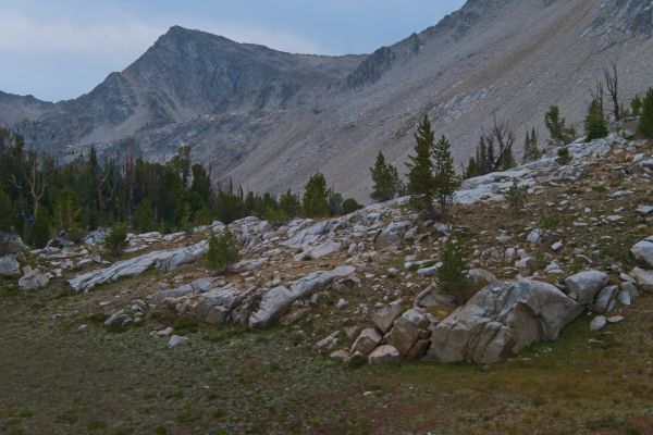 Despite foregoing fishing in favor of an earlier start crossing south to the Boulder Chain Lakes, it is already 11 am when my goal, the saddle (on the skyline, hidden behind the black buttress mid-frame), becomes apparent from the southeast end of Cove Lake.  I decide to drop down to Island Lake to take advantage of a ridge climbing southwest to the same point reached alternatively by contouring across the loose talus on the right of the photo.  This ridge is evident below the sharp peak on the skyline.
