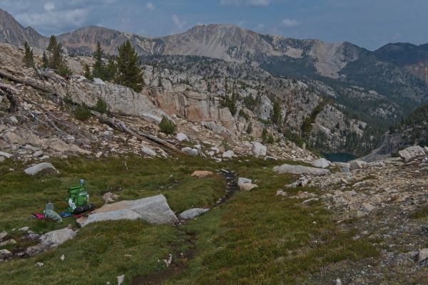 About 1 pm, I am rewarded with cool running water in the grassy drainage below two small tarns.  It’s the perfect spot to re-hydrate with an electrolyte-infused sports drink.  Island Lake is far below on the right.
