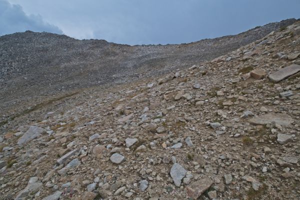 The saddle I’m standing on drops into a drainage west of Boulder Chain Lakes, which descends to Warm Springs Creek.  The correct saddle, to drop into Hummock Lake, lies higher on the ridge to the east.  That saddle in a bit east of the low point on the skyline.  It becomes obvious when one looks down into the lake basin.
