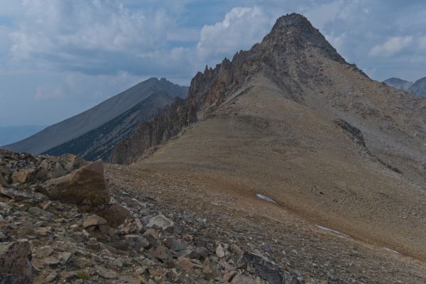 Looking northwest from the saddle between the two Boulder Lake basins past the lower saddle (above the snowfield) to D. O. Lee Peak in the distance (directly above the low point of the saddle).
