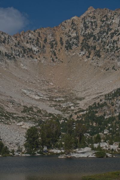 The saddle between the two Boulder Lake basins from the southeast end of Hummock Lake.  It is not readily apparent where the exact route I took crosses.  I believe it is the notch just under the cloud.  Hidden Lake is doing as its name implies.
