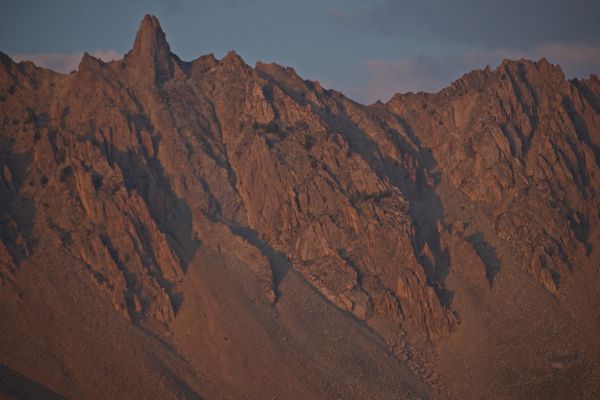 The Devil’s Staircase viewed from just east of Ants Basin; 8:00 pm.  About half way to the left edge of the frame from the distinct pinnacle, one can see the entrance to the staircase.  About 1/3 down to the bottom of the rock buttress, it divides into two branches.  The southerly branch is not visible behind the rock buttress.
