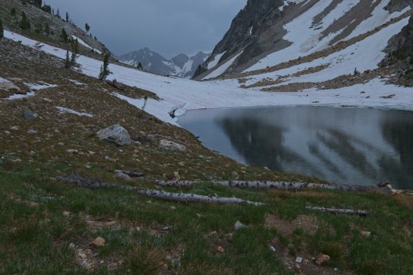 The tarn (8489 feet) at the south end of Sawtooth Lake is worth hiking to, even if one is coming from Iron Creek, and heading back the same way.  I stop here for a quick snack, seeking the shelter of the trees to avoid the sprinkles, which are becoming persistent.
