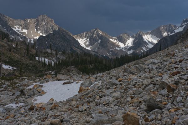 Direct sunlight from the west illuminates the snow on Baron Peak (left), and the Monte Verita ridge behind it (center and right).  I don't see the distinctive shape of Warbonnet Peak, but I am used to seeing it from the south.  It may just be hidden behind Baron Peak.  I don't stop to take out the sighting compass and figure out exactly what I am looking at, concerned about thunderstorms causing the North Fork Baron Creek to rise.
