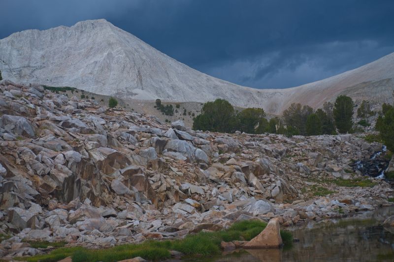 Two hours later, it is still storming up on the WCP-9 / D. O. Lee Peak saddle.  After the rain stopped down here, a strong gust of wind caused a stake anchoring a pole to pull out.  I was able to re-stake it quickly in firmer ground a bit closer to the pole.  Fortunately it happened after the downpour.
