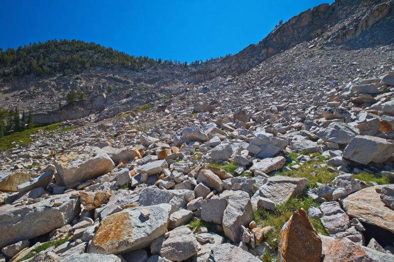 I am now ascending to the ridge which leads up and right (south) to the small tarns before the final push to the pass.  I should have descended a bit closer to Island Lake to avoid some brief boulder-hopping to gain the grassy ridge just ahead.
