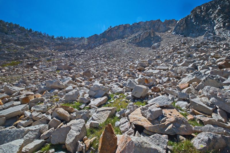 The ridge leads up a stream drainage on intermittent grass and rock buttresses just behind the right skyline.
