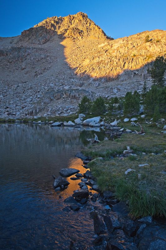 Morning sunlight hits the headwall that forms the west side of the basin.  It's another cool, clear morning, a few degrees warmer than yesterday.  Inside of the tent stayed dry again!  I plan to fish Scoop Lake, and walk out today.
