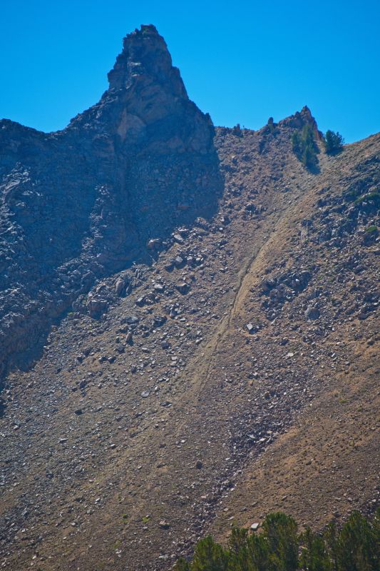 The pinnacle towering immediately south of the "Devil's Staircase", the steep pass leading to Born Lakes on the west, as photographed from just west of Windy Devil.  Looking closely reveals the useful switchbacks leading to the top.  A small pine sits in the low notch that is the pass
