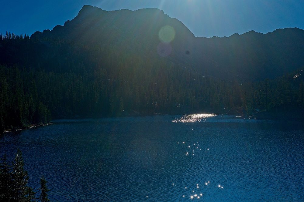 I arrive at the southeast end of Imogene Lake at 5 pm.  The sun is low enough that I really needed to shade the lens with my hand.  I want to find a campsite near the inlet.  By the time I get the tent set up, the food hang in place, and filter water, I doubt I will have time to fish.  I am not familiar with campsites here, aside from being tired.
