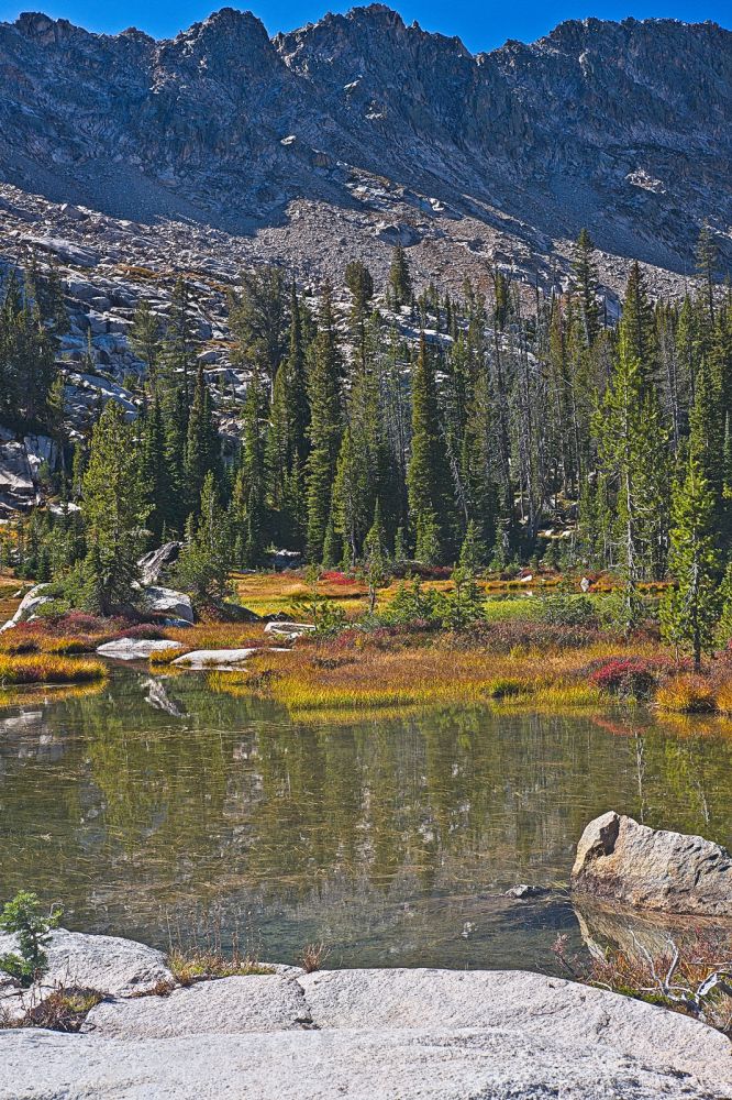 Ridge southeast of Payette Peak with a light dusting of snow above tarn and meadow; 8565'
