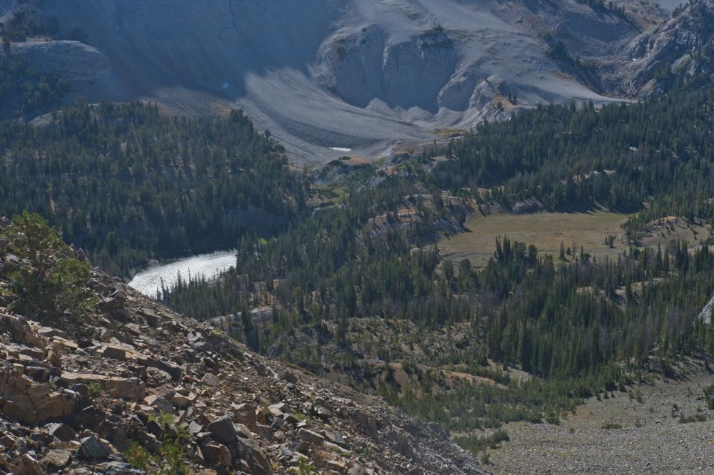 I still need water for the ascent to the saddle between D. O. Lee Peak and WCP-9.  Last year I was able to get water out of the stream flowing into Ocalkens Lake by crossing the meadow on the right, intersecting the stream well above the lake.  This year I had to descend all the way to the lake.   The climb from the lake is east of Bighorn Basin, and although steeper, the trees provide welcome shade most of the way up.
