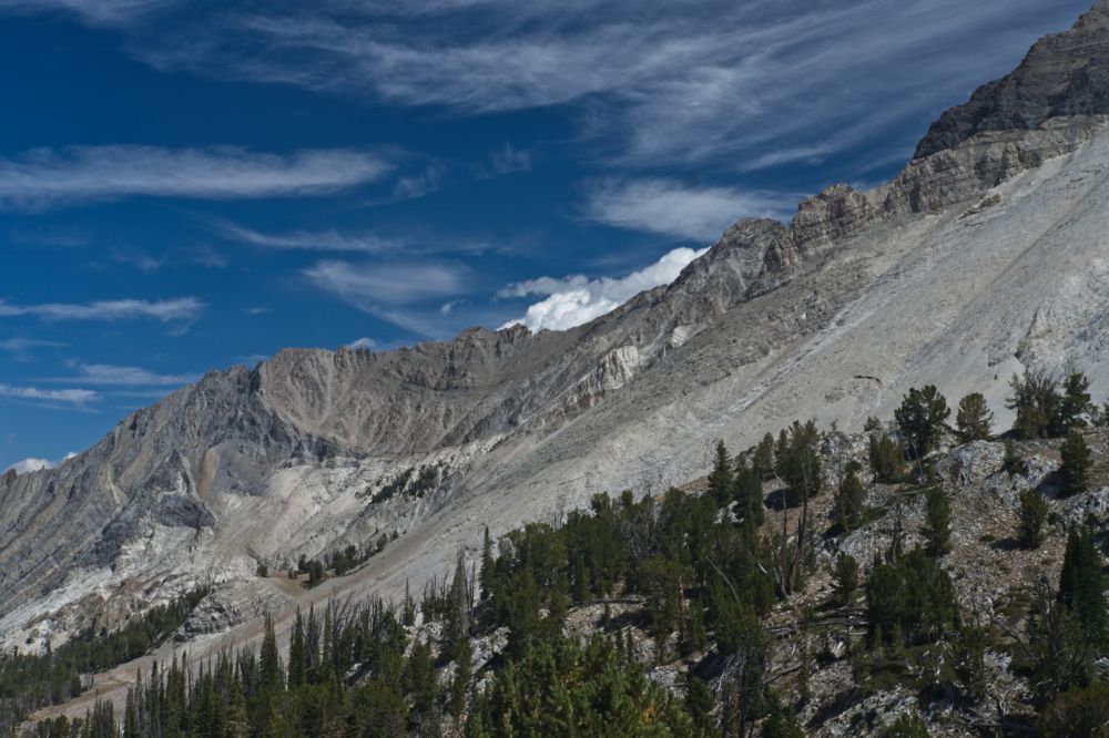 Calkens Peak on the skyline right (S) of the cumulous cloud just behind the skyline.  The western-most is the higher summit according to the Lopez book.  This peak is the next peak N of WCP-9.  It is usually ascended from the E.
