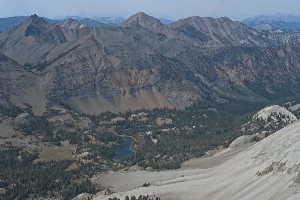 The view N past Ocalkens Lake.  The entrance to Iron Basin is high above the lake on the left (W).  The drainage below the lake, extending all the way to frame right, follows a trail down Slate Creek.  Smoke from the Wapiti fire is drifting E from Stanley.  Fortunately, it has stayed well to the N.
