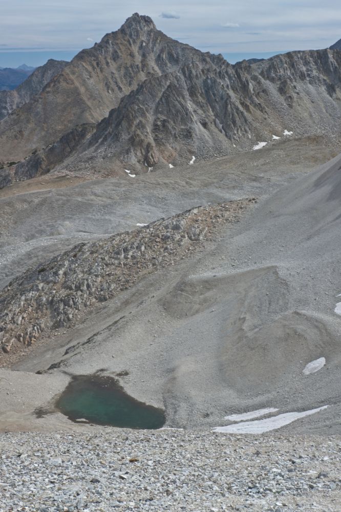 The outlet of this tarn marks my descent route.  Nice to be out of the worst of the wind!
