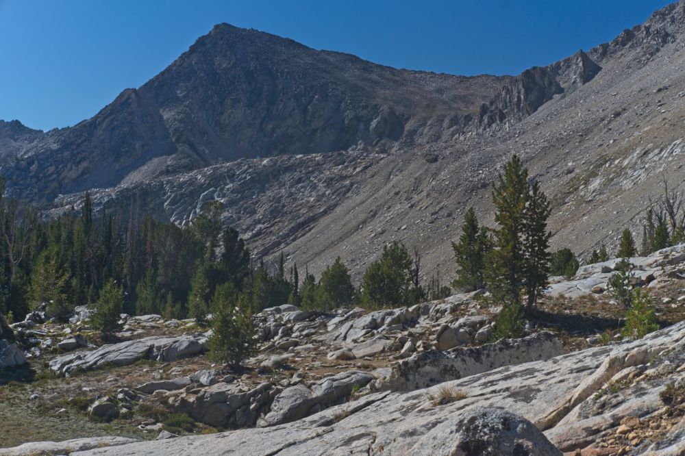 The pass between the two lake basins lies on the skyline, close to where the skyline appears to intersect the ridge in the right foreground.  There are a few ways to get there.  One can contour to the right (SW) and diagonal (SSE) up all that loose scree.  I prefer to drop down almost to Island Lake and climb the obvious ramp that begins on the left side of the frame, roughly mid frame (vertical axis) and climbs to the point mid frame (horizontal axis) just above center of frame (vertical axis), where it joins the first option.  This may be slower, but it is a much more enjoyable ascent on firm terrain that follows a pleasant stream coarse.
