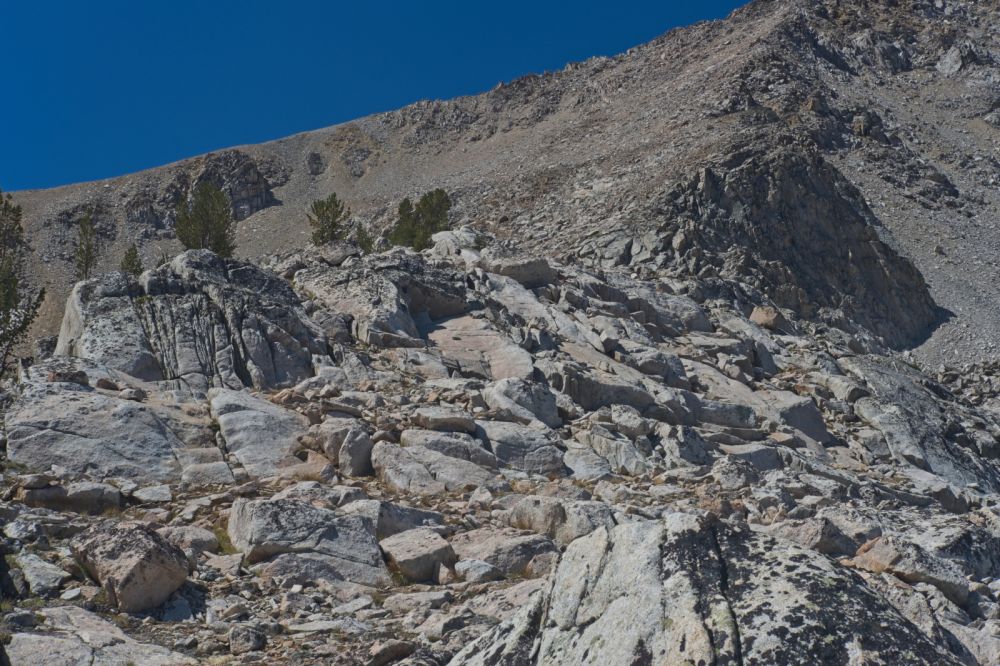 Climbing toward the pink outcrop (hidden from view); I ascend toward the dark outcrop on the ridge.
