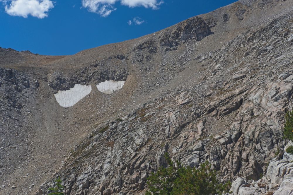 I stay to the right here, avoiding unnecessary exposure, sticking to the most solid rock to gain elevation before contouring to the first saddle above the snow patches.
