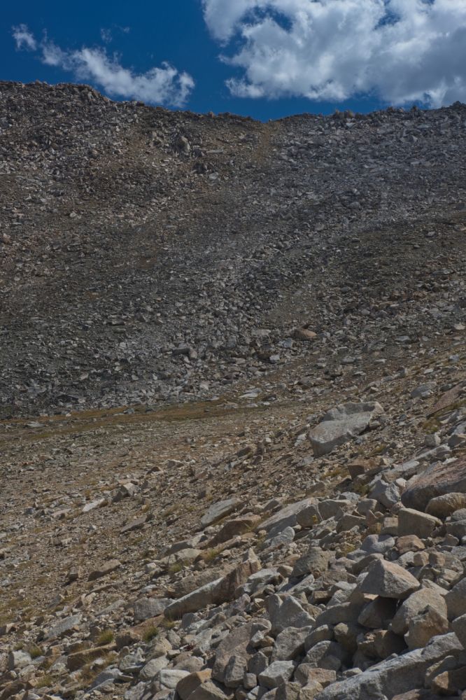 Arriving at the lower saddle, looking SSE.  The crossing is on the skyline, roughly, the middle of the frame.  There are several places one can cross, in fairly close proximity.  The only way to be sure is to look down and see if it will go safely.
