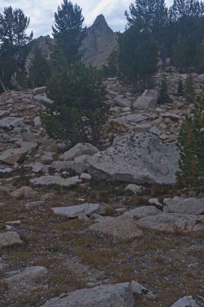 The pinnacle marking the descent down the Devil's Staircase to Born Lakes is just ahead.  This tedious route cuts a full off of the backpack into Boulder Chain Lakes.  Not that Four Lakes Basin and Quiet Lake are not worth visiting.  Note the hail on the ground.  Fortunately it was soft like snowflakes, rather than hard like marbles.
